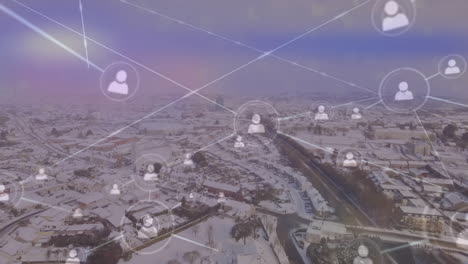 animation of network of profile icons and light spot against aerial view of winter landscape