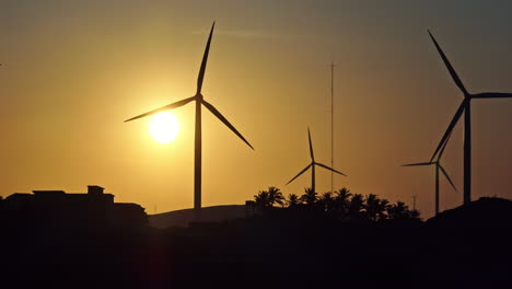 Silhouettes-of-wind-turbines-at-a-kitesurf-beach-in-Brazil-during-sunset