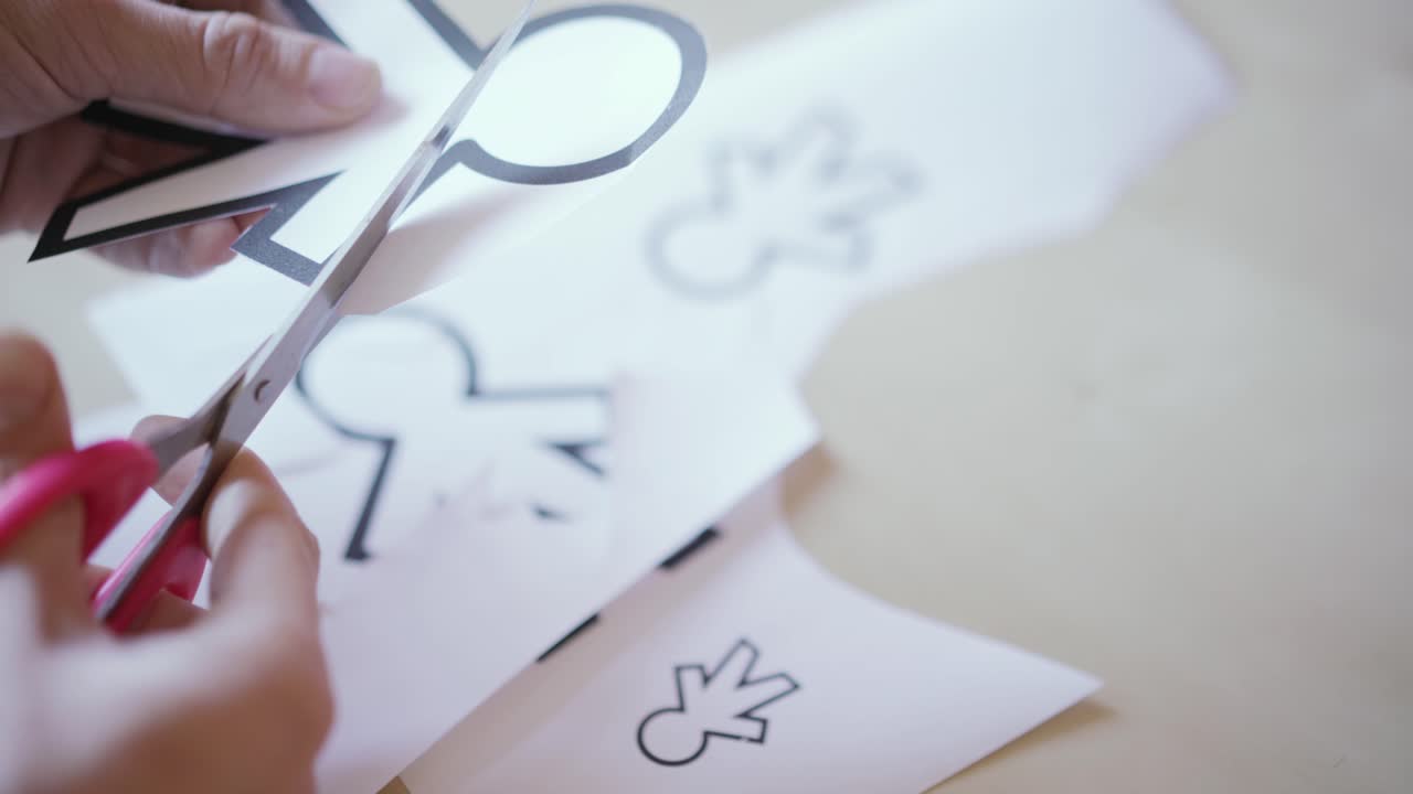 tijeras cortando diferentes siluetas de papel para el día de los tontos de abril