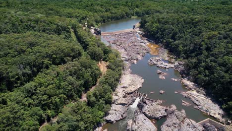lush forest surrounds river dam at barron falls, scenic rail nearby, peaceful vibe