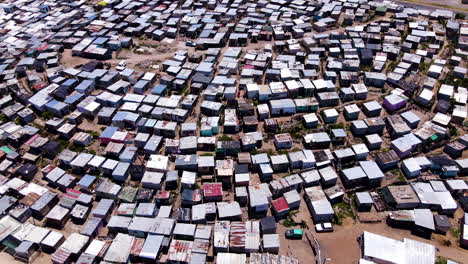 crowded township - makeshift tin houses on hill of informal settlement