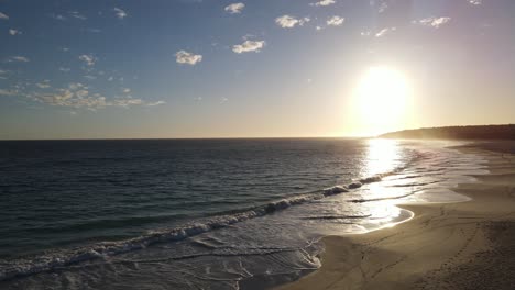 Drone-aerial-during-sunrise-over-a-beautiful-blue-beach-in-Western-Australia