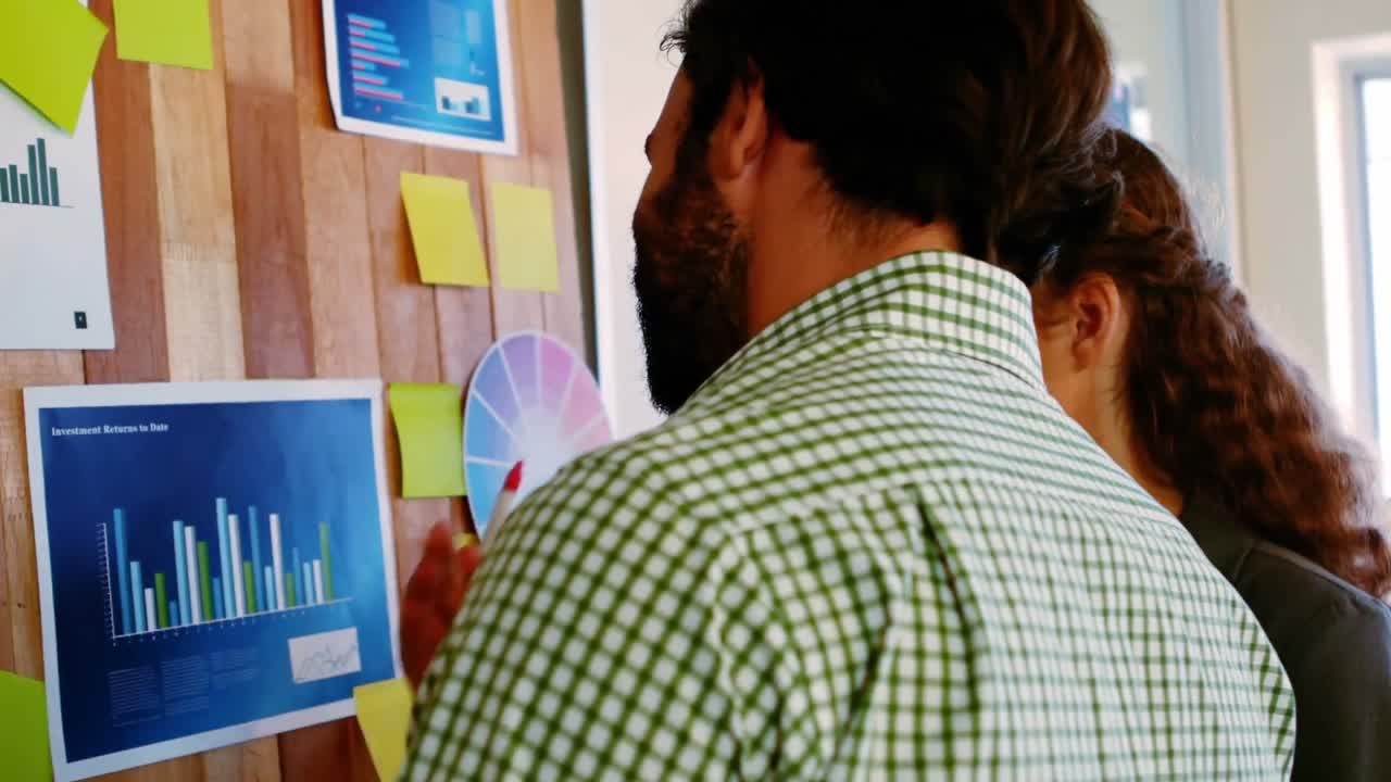 hombres y mujeres ejecutivos de negocios discutiendo sobre el gráfico