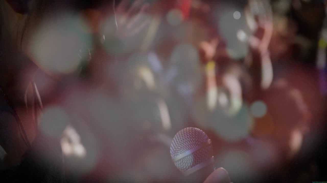 Singer holding microphone while animated sound waves pulsing over bokeh lights for music marketing