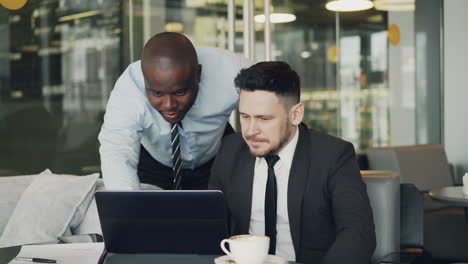 business colleagues collaborating in a cafe