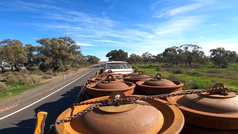 shot taken from the top of a truckload, landscape with low vegetation and blue sky with clouds on the horizon