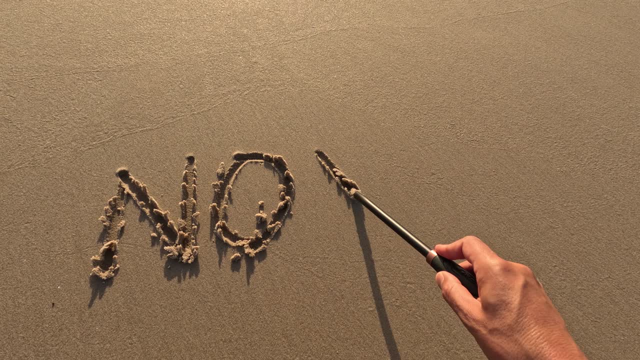 &amp;quot;No War&amp;quot; word is written on the sandy beach