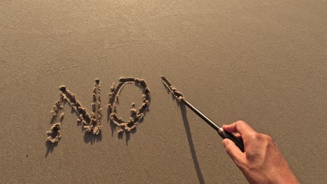 "no war" word is written on the sandy beach