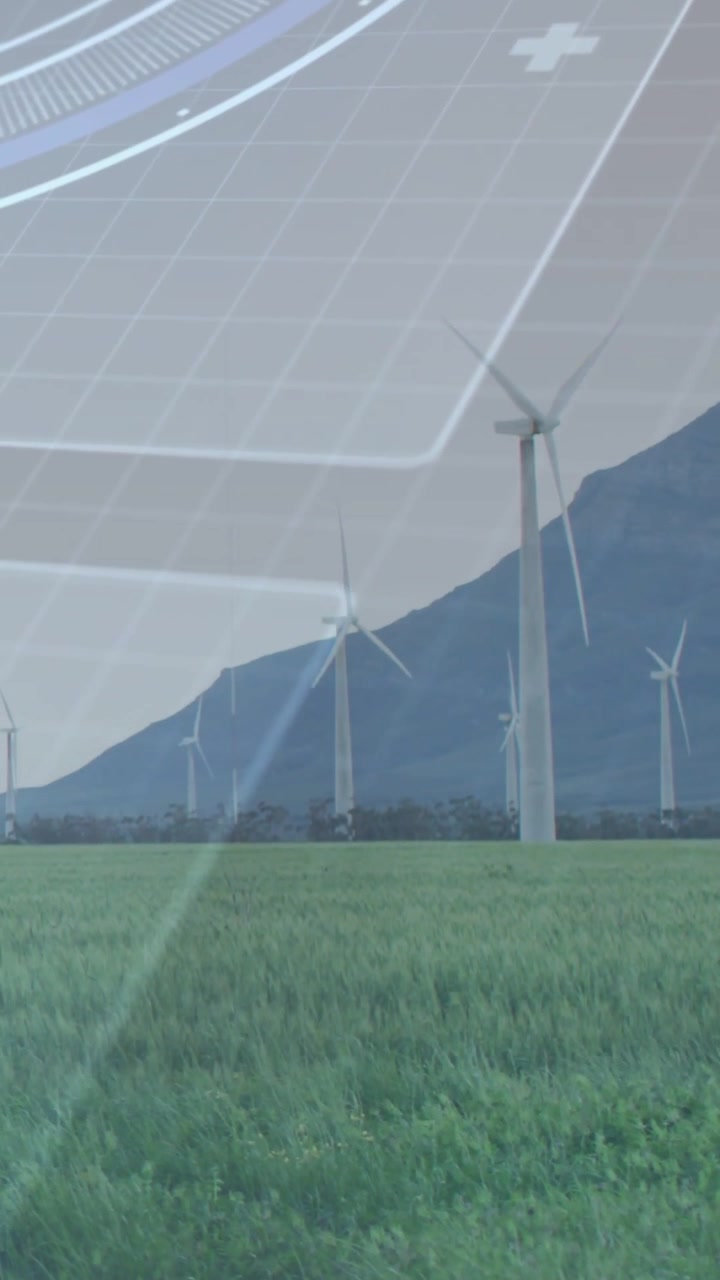 Video verticale: Vento che aziona una turbina che gira in pianura, sovrapposizione HUD che si sposta con la luce per l'energia.