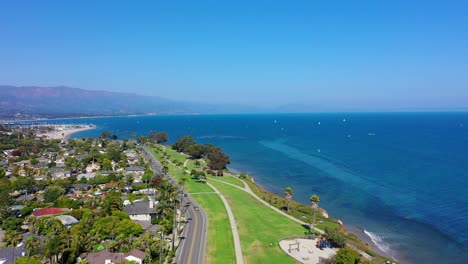 Flying-over-the-highway-with-a-beautiful-view-of-the-beach-in-Santa-Barbara,-California