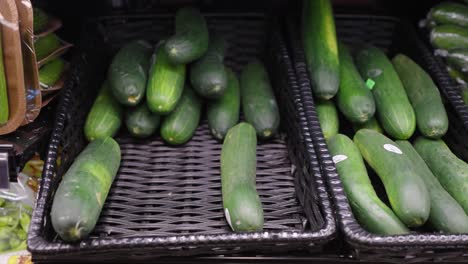 fresh cucumbers on display in a grocery store