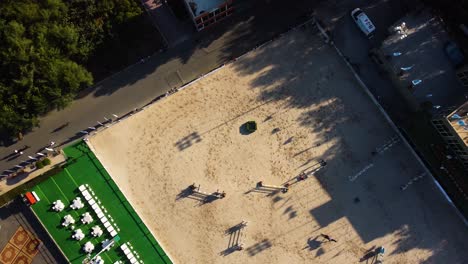 orbit shot over horseback riding sandy field during competition, jeddah, saudi arabia