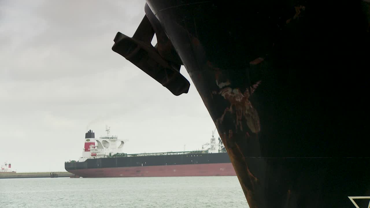 Cargo ship in Rotterdam port, cloudy weather, transport feeling