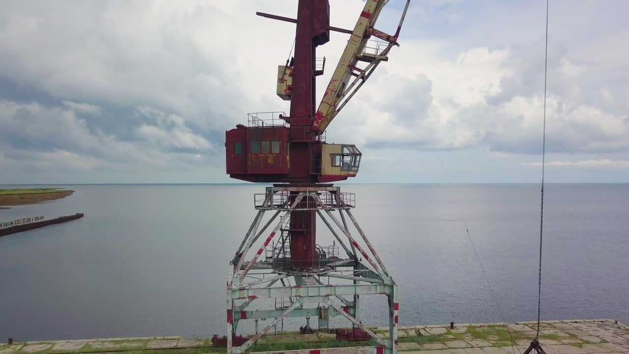 An old abandoned rusty crane in the seaport.