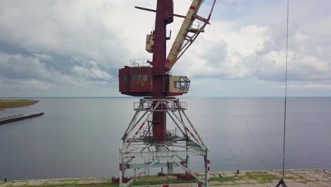 an old abandoned rusty crane in the seaport.