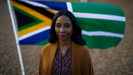 south african woman in front of flag
