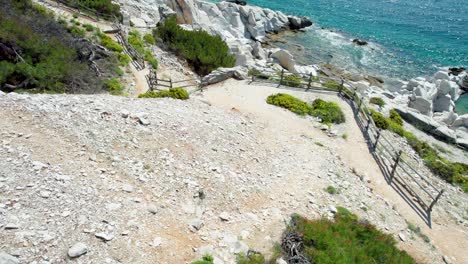 Top-Down-View-Over-Aliki-Ancient-Marble-Quarry-With-Turquoise-Water-And-Large-White-Pieces-Of-Marble,-Thassos,-Greece