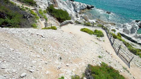 top down view over aliki ancient marble quarry with turquoise water and large white pieces of marble, thassos, greece