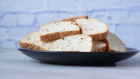 crispy bread slices on a dark plate