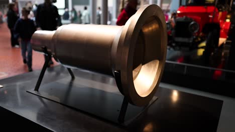 large metallic object with visitors around