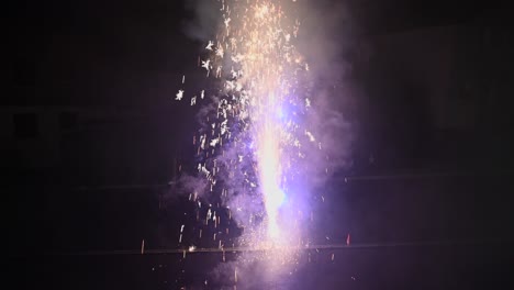 colorful sparkles and smoke from a firework during the new year and in a dark atmosphere