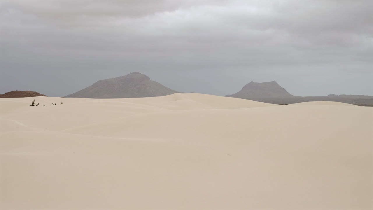 Nice view of sand dunes in Viana desert close up at overcast day, background volcanic mountains, Boa vista , Cape Verde