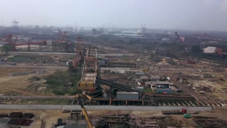 Ongoing-Development-Of-Paradip-Port-In-Orisha,-India-In-A-Cloudy-Day---revolving-aerial-shot