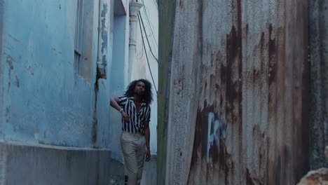 cool looking black man posing in blue color street of old town