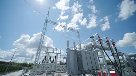 high voltage transformer against the blue sky. electric current redistribution substation