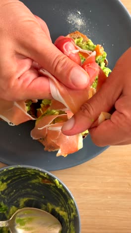 preparing avocado toast with prosciutto
