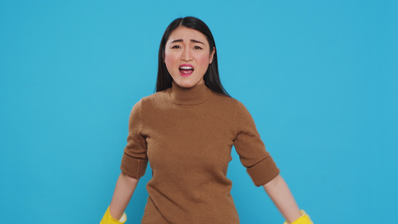 Asian homemaker doing time out gesture during house cleaning