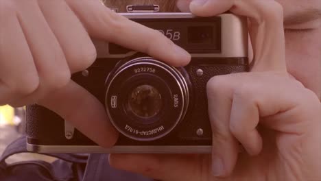 man using a vintage film camera