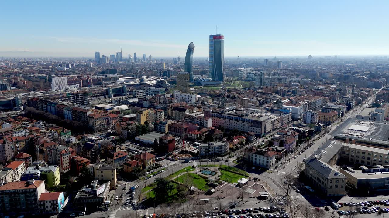 Aerial drone view of Milan skyline, showcasing city skyscrapers and traffic highway road
