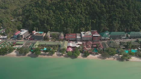 aerial view of white sand beach and empty resorts due to travel restrictions