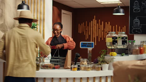 african american woman greeting client at checkout counter