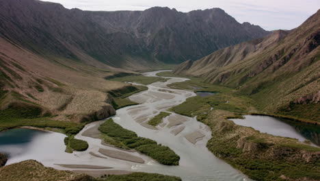 braided river flowing through a vast mountain valley
