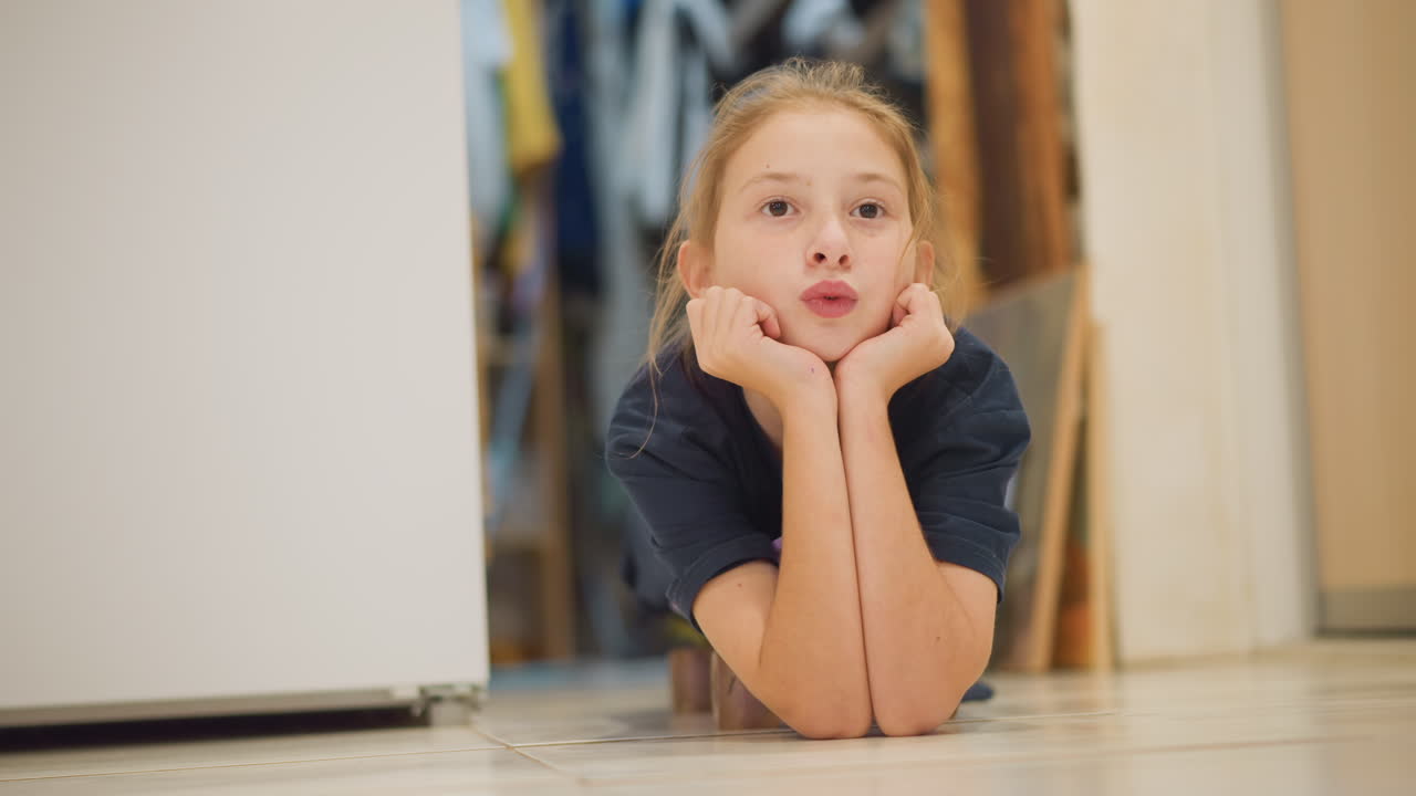 Child attentively observes culinary activities happening peacefully in household setting. Young girl calmly observes her parent involved in preparing and cooking meal at home environment