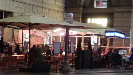 restaurant tables outside at night on sidewalk in europe, new york