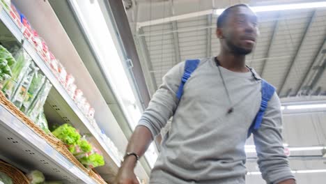 man shopping for vegetables in a grocery store