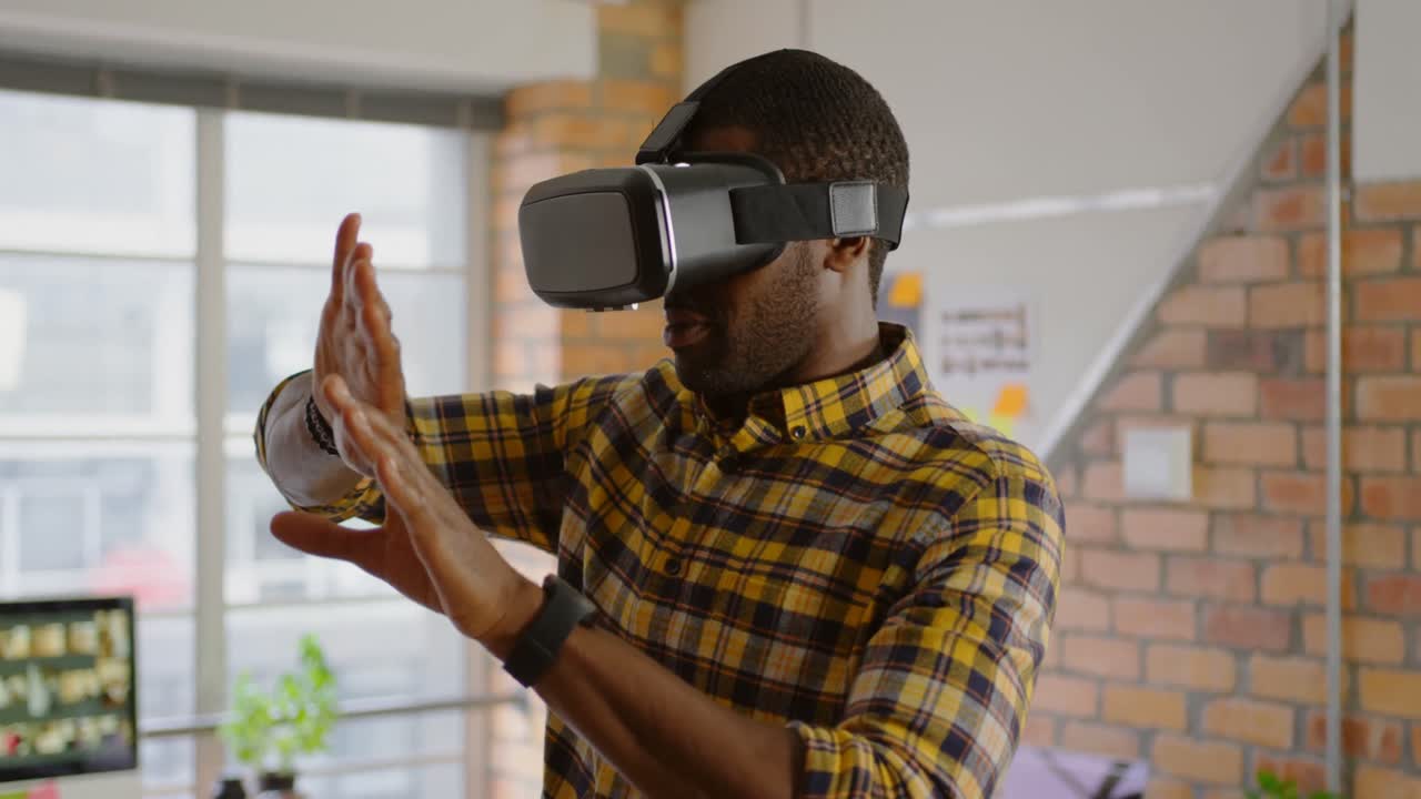 Male graphic designer using virtual reality headset in office 4k