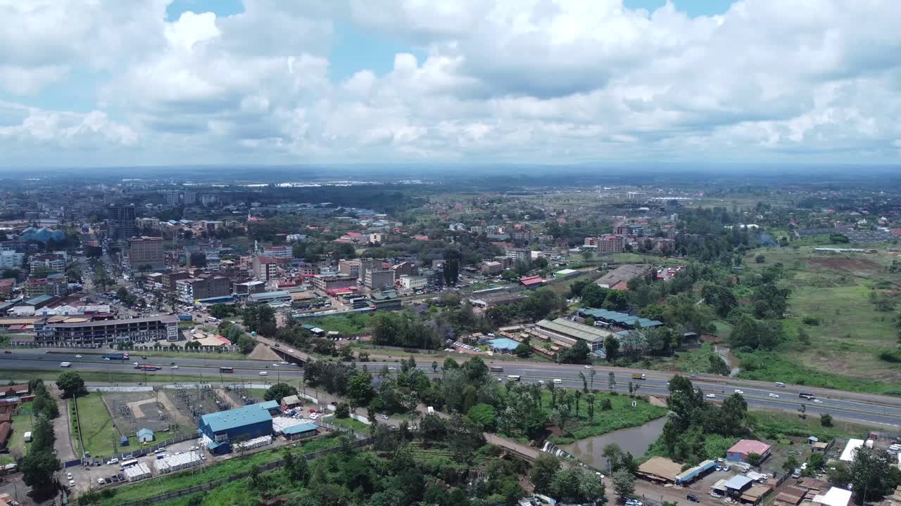 Ruiru, a suburb near nairobi with roads, buildings, and greenery under a cloudy sky, aerial view