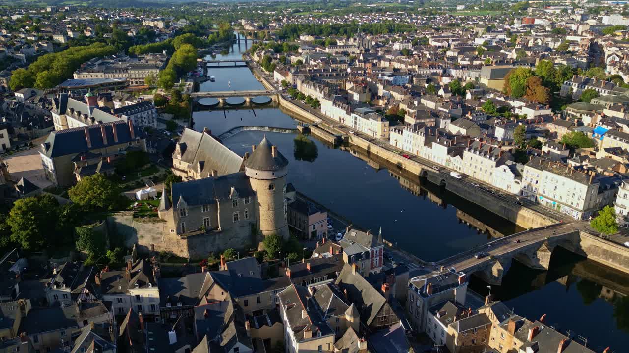 Drone gradual pullback above Chateau de Laval with Pont Vieux bridge crossing the river in foreground