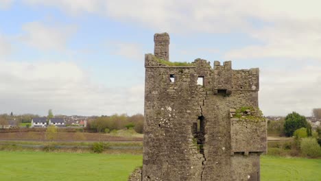 Srah-Castle-broken-walls-and-chipped-brick-side,-birds-soar-between,-aerial-crane