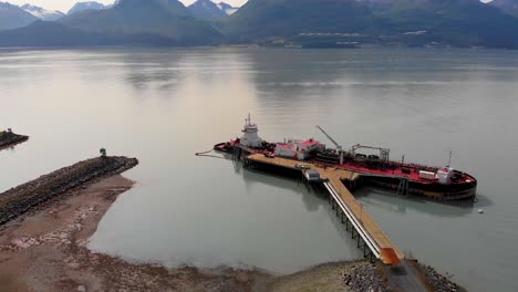 4k drone video of commercial ship in valdez, alaska during sunny summer day