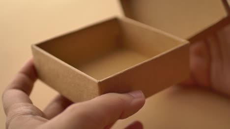 top view of person open a empty small gift box ,