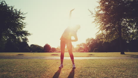 woman exercising outdoors in park morning