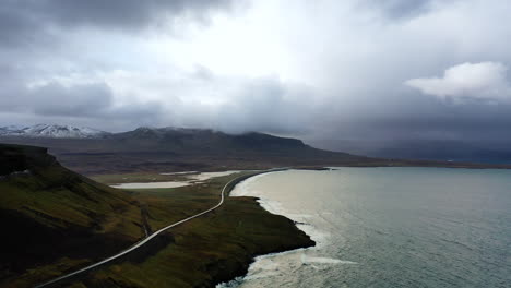 drone footage flying over a crazy road by the ocean