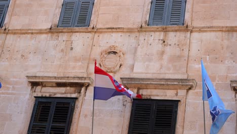 low angle shot of croatian flying on an old historic building in old city of dubrovnik, croatia at daytime