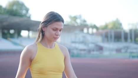 woman jogging on outdoor track in sportswear at athletic field