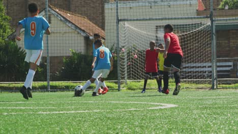 soccer kids playing in a sunny day